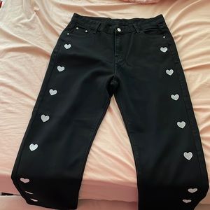 High waisted black pants with white hearts.